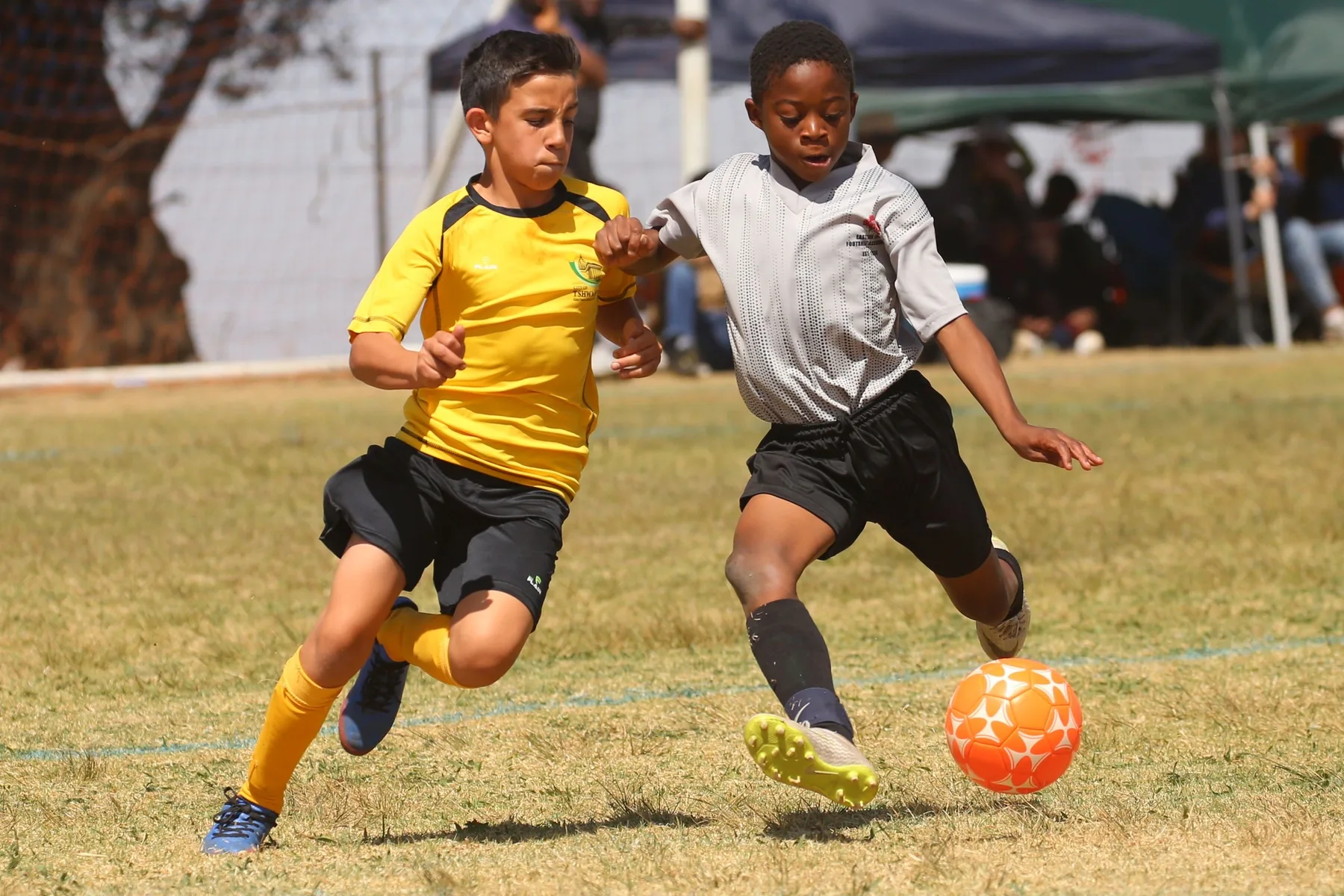 Two young soccer players chasing the ball