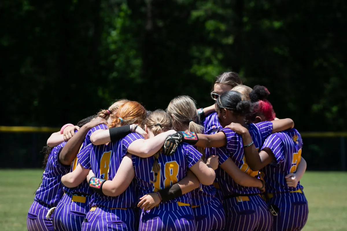 Softball team in a huddle